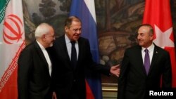 FILE - Foreign Ministers Mohammad Javad Zarif of Iran, Sergey Lavrov of Russia and Mevlut Cavusoglu of Turkey gather for a photo following their meeting in Moscow, April 28, 2018.