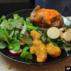 Dinner at one Maryland group home features greens and turnips, salad with radishes and peppers, and sweet potatoes - all grown at Red Wiggler Farm.
