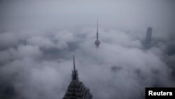 China -- Skyscrapers Oriental Pearl Tower and Jin Mao Tower (L) are seen from the Shanghai World Financial Center, in rain at the financial district of Pudong in Shanghai, January 28, 2016