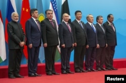 Russian President Vladimir Putin is seen during a photo session of the SCO (Shanghai Cooperation Organisation) Heads of State ahead of a meeting of the SCO Council of Heads of State in Qingdao, China, June 10, 2018.