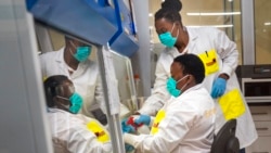 Medical scientists Melva Mlambo, right, and Puseletso Lesofi prepare to sequence COVID-19 omicron samples at the Ndlovu Research Center in Elandsdoorn, South Africa, Dec. 8, 2021.