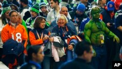 Football fans wait to go through security at the Secaucus Junction, Feb. 2, 2014, in Secaucus, N.J.
