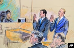 A court artist drawing shows President Donald Trump's former campaign chairman, Paul Manafort, center standing and Manafort's business associate, Rick Gates, in federal court in Washington, Oct. 30, 2017, before U.S. Magistrate Judge Deborah A. Robinson.