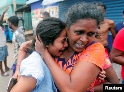 People who live near the church that was attacked yesterday, leave their houses as the military try to defuse a suspected van before it exploded in Colombo, Sri Lanka, April 22, 2019.