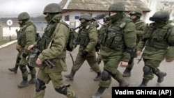 UKRAINE – Russian soldiers march outside an Ukrainian military base in Perevalne, Crimea, March 20, 2014