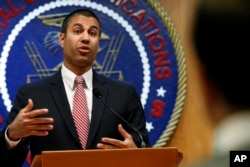 FILE - Federal Communications Commission Chairman Ajit Pai answers a question from a reporter in Washington, Dec. 14, 2017.