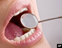 Fluoride disease is blamed for an outbreak in China that blackened teeth, caused very brittle bones and bone deformation.