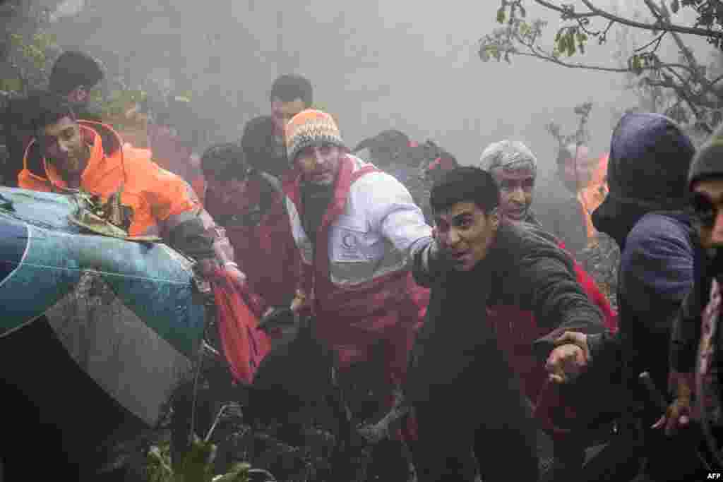 Rescuers recover bodies at the crash site of a helicopter transporting Iran&#39;s President, his Foreign Minister, and others in a fog-covered mountainous area of Varzaghan in northwestern Iran, May 20, 2024.