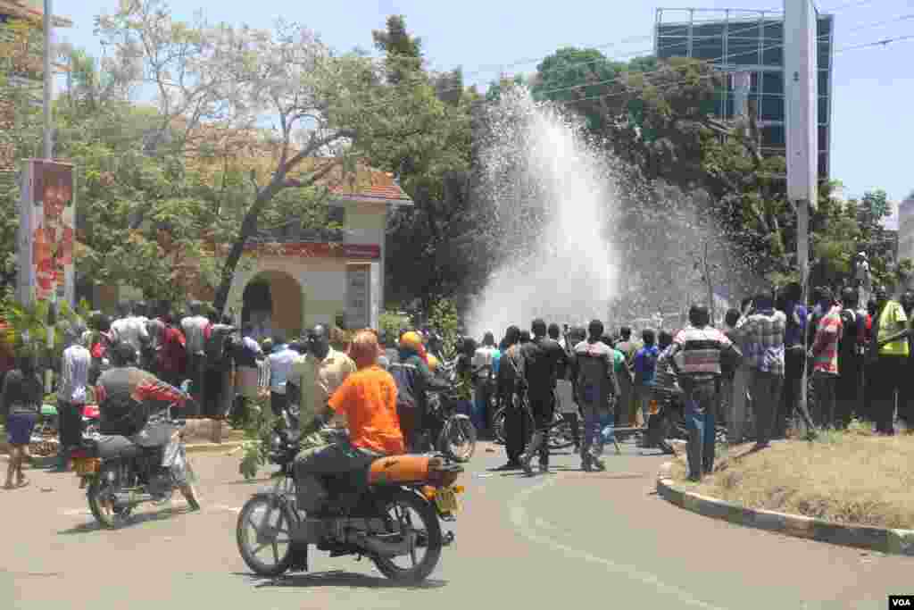 Protesters break a water line in the center of Kisumu, Kenya, during anti-electoral commission protests on October 6, 2017, ahead of the upcoming re-run presidential election. (VOA/J. Craig