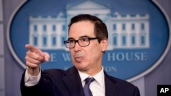 FILE - US Treasury Secretary Steven Mnuchin takes a question from a reporter.