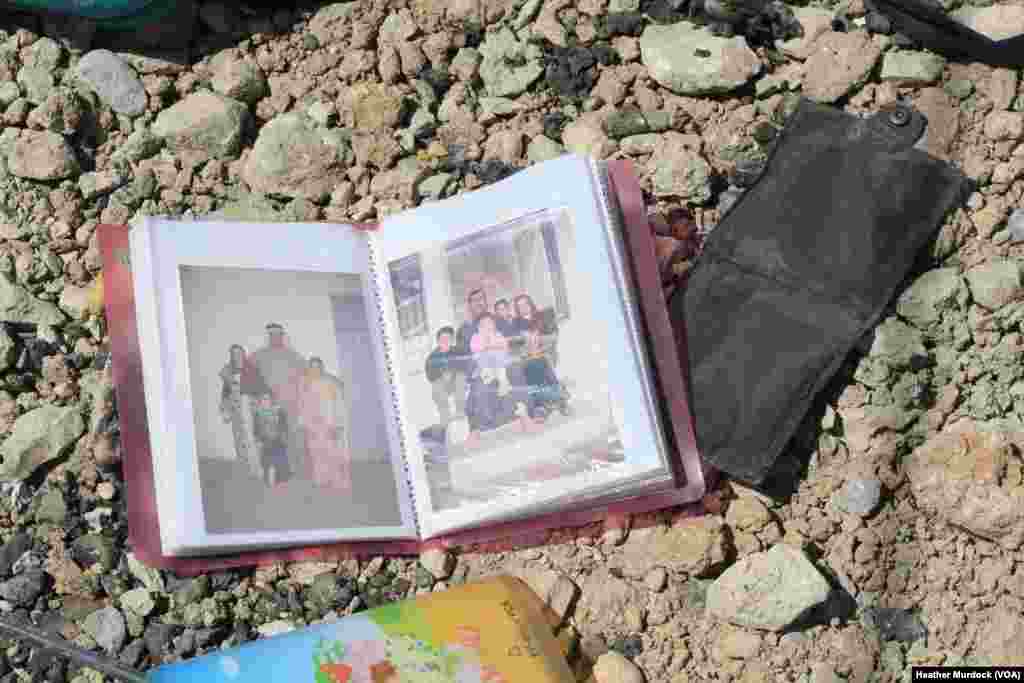 An family photo album lies among debris and blood where civilians were shot down by Islamic State snipers in early June, in Mosul, Iraq, June 15, 2017.