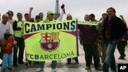 Des supporters de Barcelone arborent une banderole de leur équipe près de la Tour Eiffel à Paris, France, 17 mai 2006.