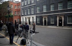 FILE - A general view of journalists outside Downing Street, London, England, April 8, 2020.