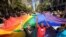 Mark Wilson, right, helps carry a rainbow flag during San Francisco's 42nd annual Gay Pride parade on Sunday, June 24, 2012. (AP Photo/Noah Berger)