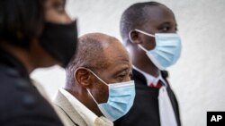 Paul Rusesabagina, center, who inspired the film 'Hotel Rwanda' for saving people from genocide, appears at the Kicukiro Primary Court in Kigali, Rwanda, on Sept. 14, 2020.