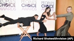 Wilmer Valderrama, from left, Jordana Brewster and Piper Perabo pose for a "Mannequin Challenge" video at the People's Choice Awards 2017 nominations press conference on Tuesday, Nov. 15, 2016, in Beverly Hills, Calif.