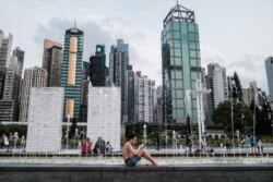 A man sits next to a fountain at the Sun Yat Sen Memorial Park in Hong Kong on April 21, 2020.