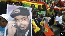 Supporters of Ethiopia People Revolutionary Front (EPRDF) hold a poster bearing Ethiopian Prime Minister Meles Zenawi, 20 May 2010
