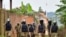 Ugandan riot police patrol an area near the house of presidential candidate and singer Robert Kyagulanyi Ssentamu, known as Bobi Wine, in the Magere neighborhood of Kampala, Uganda, Jan. 16, 2021.