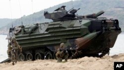 U.S. Marines jump off an amphibious assault vehicle after hitting the ground at a join military exercise, 'Cobra Gold' on Hat Yao beach in Chonburi province eastern, Thailand.