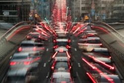 FILE - In this slow-shutter zoom effect photo taken Dec. 12, 2018, commuters are backed up in traffic during the morning rush hour in Brussels, a city that regularly experiences pollution alert warnings.