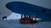Maritime police search for missing passengers in front of the South Korean ferry that sank near Jindo, South Korea, April 16, 2014. 
