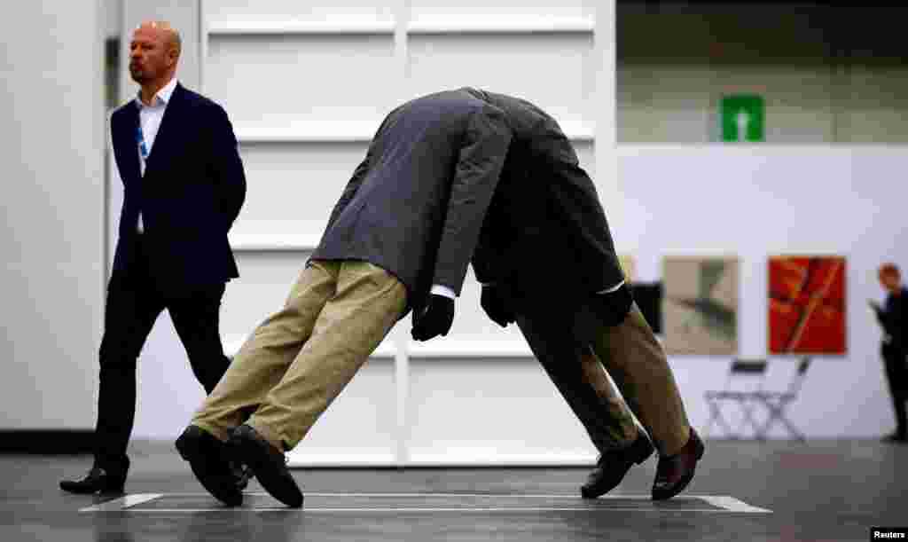 Demonstrators spray water on a man who tried to set himself on fire during a protest demanding the removal of Algeria&#39;s ruling elite, in Algiers.
