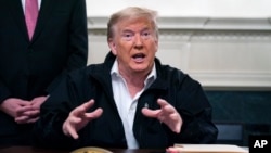 FILE - President Donald Trump talks to reporters during the signing of a spending bill to combat the coronavirus, at the White House March 6, 2020, in Washington.