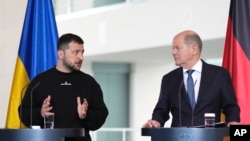 Germany's Chancellor Olaf Scholz, right, and Ukraine's President Volodymyr Zelenskyy address a media conference at the chancellery in Berlin on May 14, 2023. (Matthias Schrader/AP)