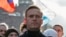 FILE - Russian opposition politician Alexei Navalny takes part in a rally to mark the 5th anniversary of opposition politician Boris Nemtsov's murder and to protest against proposed amendments to the country's constitution, in Moscow, Feb. 29, 2020.