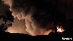 Smoke and flames are seen near Mezzah military airport, outside Damascus, Syria, in this still image from video obtained by Reuters Jan. 13, 2017.
