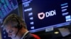 FILE - A trader works during the IPO for Chinese ride-hailing company Didi Global Inc on the New York Stock Exchange (NYSE) floor in New York City, June 30, 2021. 