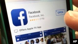 FILE - In this June 19, 2017, file photo, a user gets ready to launch Facebook, in North Andover, Mass. Facebook announced Nov. 29, 2017, that the company is giving disaster-relief organizations access to data on what users need.