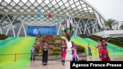 Dancers perform outside the venue of the UN Biodiversity Conference (COP 15) in Kunming, in China's southwestern Yunnan province on Oct. 11, 2021. 