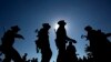 FILE - Ta’ang National Liberation army officers join a traditional line dance with civilians during a celebration in Mar-Wong Village, northern Shan state, Myanmar, marking their insurrection more than a half-century ago, Jan. 12, 2015. 