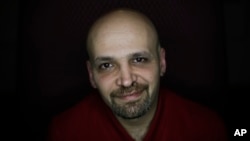 Mahmoud Hassino a homosexual Syrian refugee and gay activist with the Schwulenberatung activist group, poses for the photographer after a news conference in Berlin, Germany, Feb. 22, 2016.