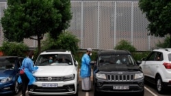 In this file photo, medical technicians administer COVID-19 swab tests at a drive-through testing site at Wits University, Braamfontein, Johannesburg, South Africa, Jan. 5, 2021. (AFP)