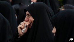A woman weeps during a mourning ceremony for Iranian President Ebrahim Raisi in downtown Tehran on May 20, 2024. Iranian state media reported on May 24 that investigators found no evidence that Raisi's helicopter was attacked before it crashed in a remote area of Iran.