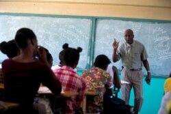 Students listen to school Director Jean Marc Charles at the Lycée school, which reopened about a week earlier than other schools in Petion-Ville, Haiti, Nov. 28, 2019.