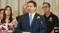 Florida Gov. Ron DeSantis answers questions related to school openings and the wearing of masks in Surfside, Fla. (AP Photo/Marta Lavandier)
