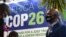 FILE - People stand by the Africa pavilion at the previous COP26 U.N. Climate Change Conference in Glasgow on Nov. 2, 2021.