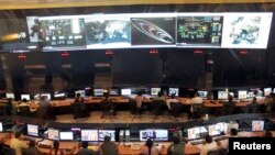 Indian Space Research Organization (ISRO) scientists and engineers monitor the movements of India's Mars orbiter at their Spacecraft Control Center in the southern Indian city of Bangalore November 27, 2013. The orbiter after circling Earth for 20 to 25 d