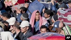 Egyptian, Tunisian and Libyan refugees in Ras Ajdir at the Tunisia-Libya border, Tuesday, March 1, 2011