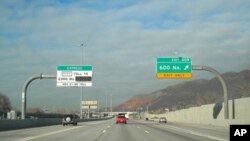 The lane to the left, in Utah, has all the trappings of a HOT lane. High-occupancy-vehicle drivers pay no toll. Lone drivers do.