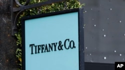 The Tiffany & Co. sign hangs in a shop window in London, Monday, Nov. 25, 2019. French luxury group LVMH has agreed to buy iconic New York jeweler Tiffany & Co. for $16.2 billion, adding a famed star to its portfolio that already boasts Louis…