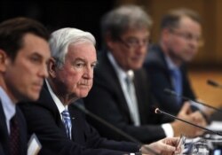 FILE - Craig Reedie, second from left, president of the World Anti-Doping Agency, (WADA), listens to a question during a news conference.