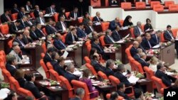 The newly-elected lawmakers from pro-Kurdish Peace and Democracy Party, last two rows, sit the parliament with the members of other parties in Ankara, Turkey, October 1, 2011. 