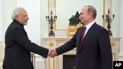 Presiden Rusia Vladimir Putin, kanan, menyambut Perdana Menteri Narendra Modi saat bertemu di Kremlin di Moskow, Belarus, Rusia, Rabu, 23 Desember 2015.