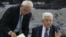 Palestinian president Mahmud Abbas (R) gestures as he signs a request to join 15 United Nations agencies at his headquarters in the West Bank city of Ramallah on April 1, 2014.
