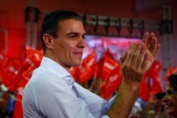 FILE - Spain's Socialist leader and acting Prime Minister Pedro Sanchez applauds as he attends a rally in Seville, Spain, Oct. 31, 2019.